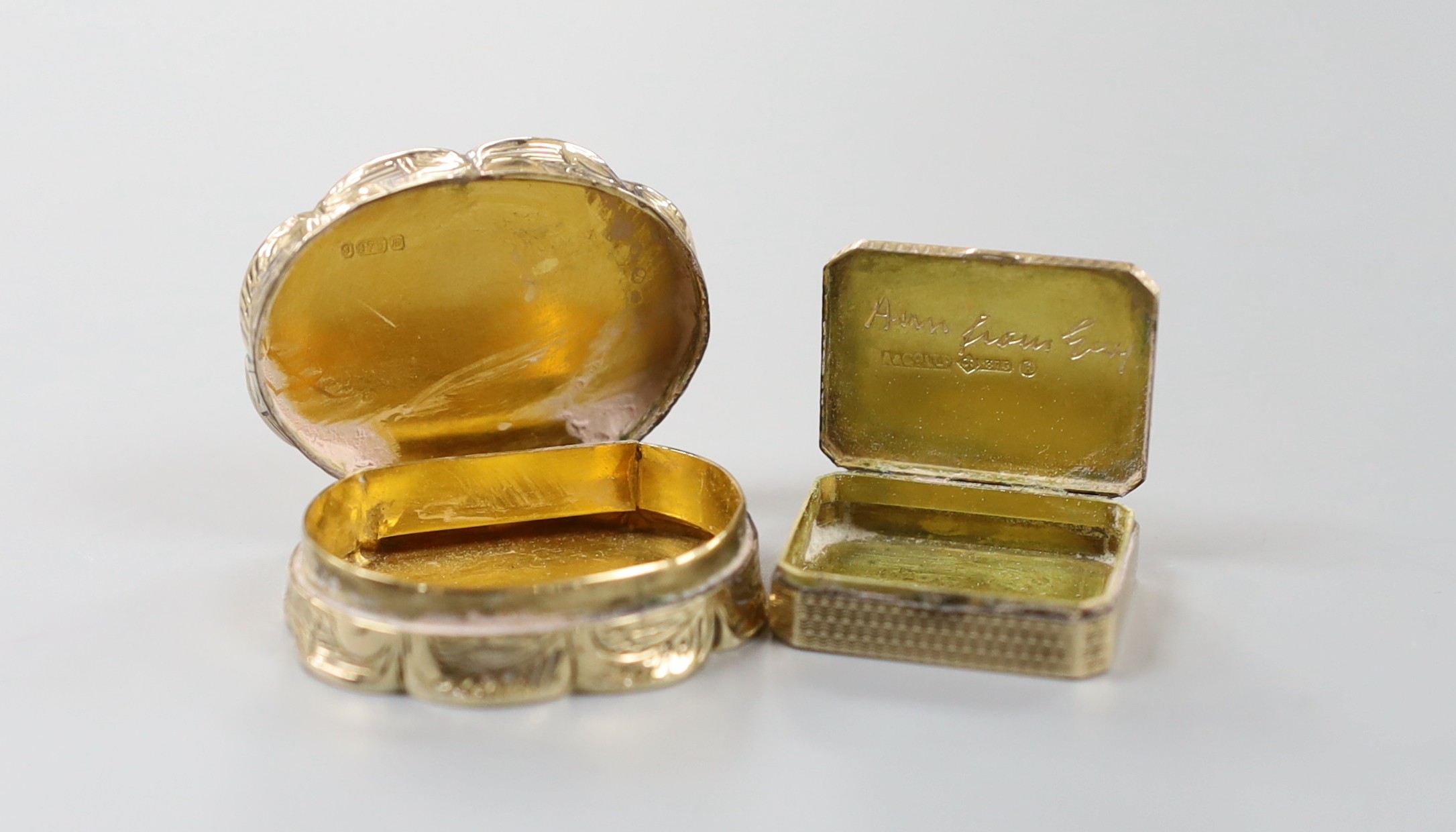 A 1960' 9ct gold shaped oval pill box, 35mm, 22.5 grams and a 9ct gold pill box by Asprey & Co, London, 1925, 25mm, 7.6 grams.